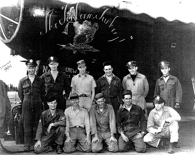 Six men standing and five men kneeling in front of the Clobbered Turkey.